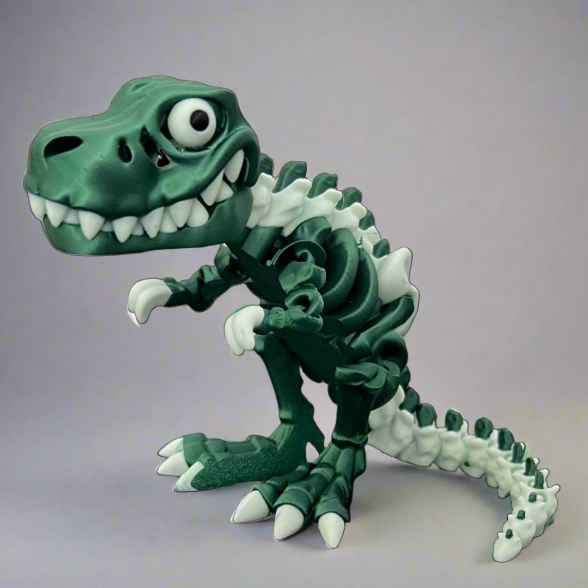 Metallic green and white articulated Tyrannosaurus Rex skeleton sensory toy, limited series.